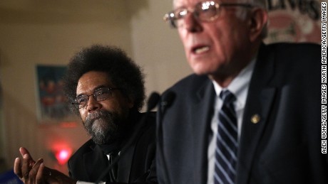 Democratic presidential candidate Sen. Bernie Sanders speaks to voters as philosopher and social activist Cornel West listens during a campaign rally in Iowa. 