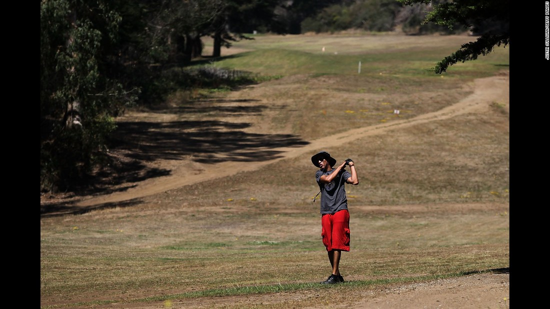 A golfer in San Francisco hits a shot in July. After Gov. Jerry Brown ordered a statewide water-use reduction of 25%, golf courses have been struggling to keep their fairways and greens watered.