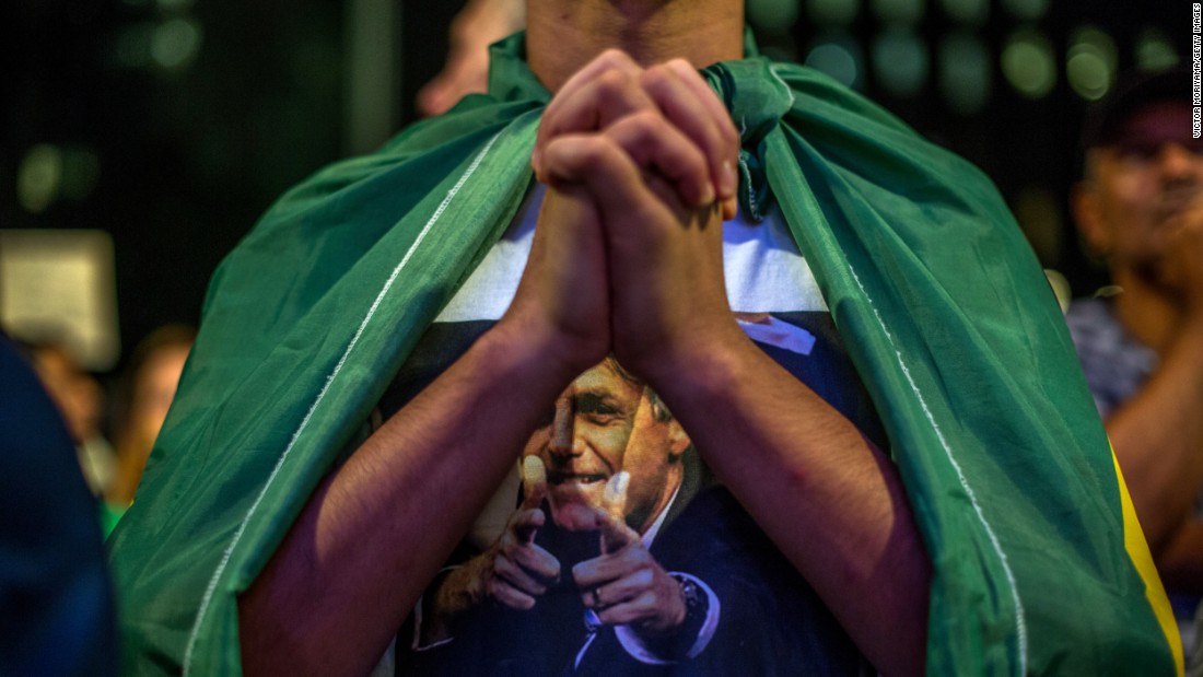 A demonstrator clasps his hands during protests in Sao Paulo on March 17.