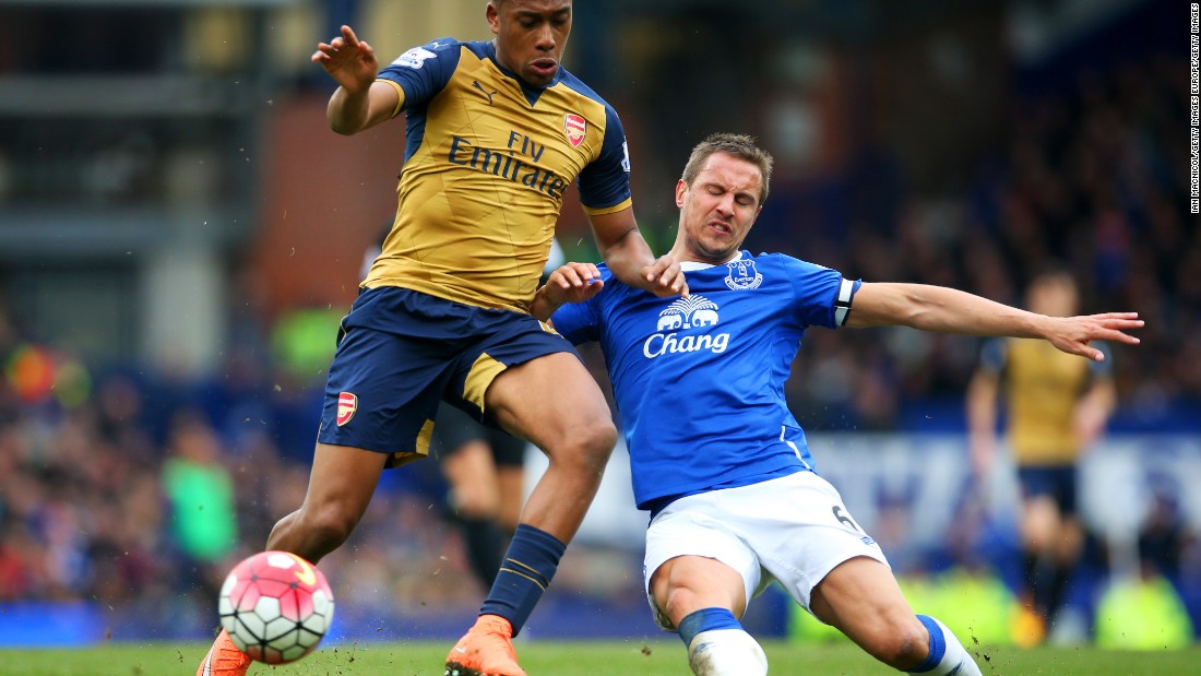 Arsenal&#39;s Nigerian 19-year-old winger Alex Iwobi (left) made his first-team debut with a stunning goal against Everton. Here he battles defender Phil Jagielka during the Premier League match at Goodison Park. 