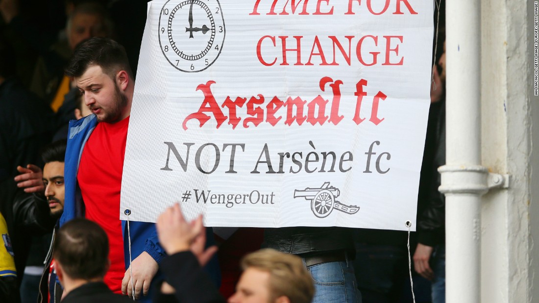 Despite Arsenal&#39;s 2-0 win, a disgruntled  Arsenal supporter holds a banner asking to replace manager Arsene Wenger after the Premier League match at Goodison Park on March 19, 2016 in Liverpool, England.