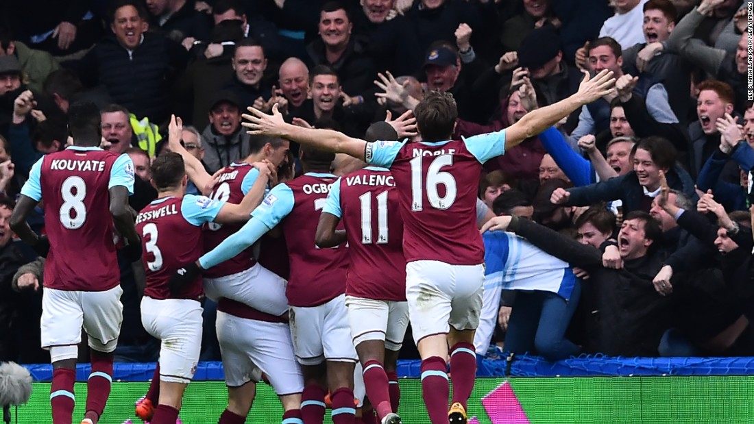 West Ham United players celebrate a goal with away supporters during the English Premier League football match on Saturday at Stamford Bridge. West Ham are battling to finish in the top four for the first time since the establishment of the Premier League in 1992. 