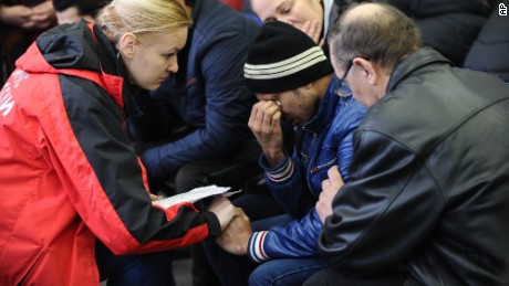 A Russian Emergency Situations Ministry employee (L) tries to comfort a relative of the plane crash victims at the Rostov-on-Don airport.