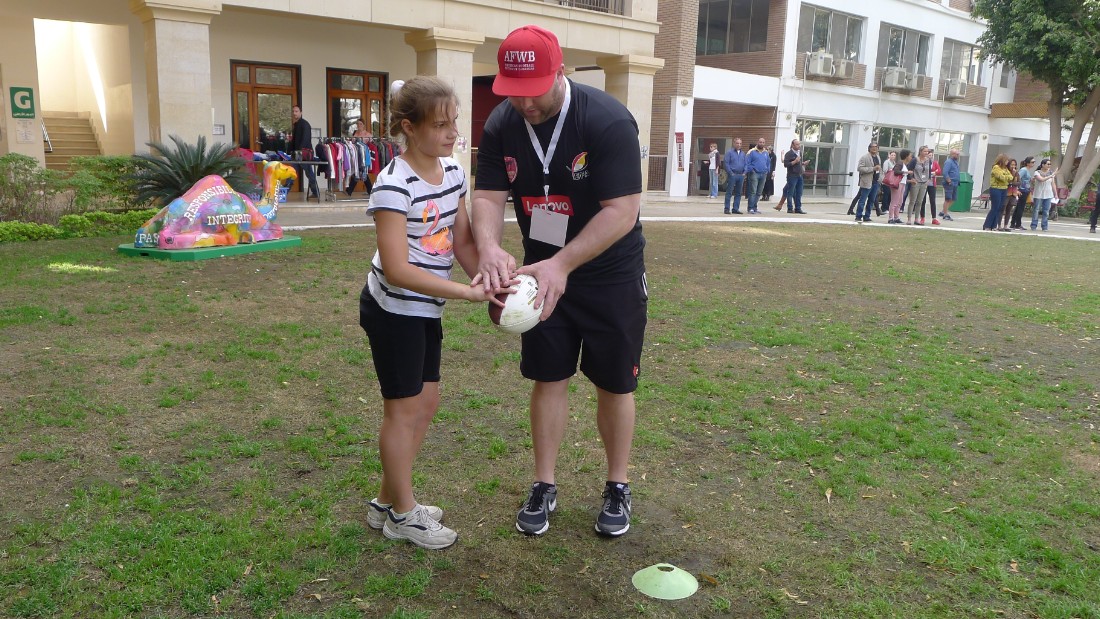 A schoolgirl from the Cairo suburb of Maadi receives coaching at the American Football Without Barriers (AFWB) camp at the Cairo American College.