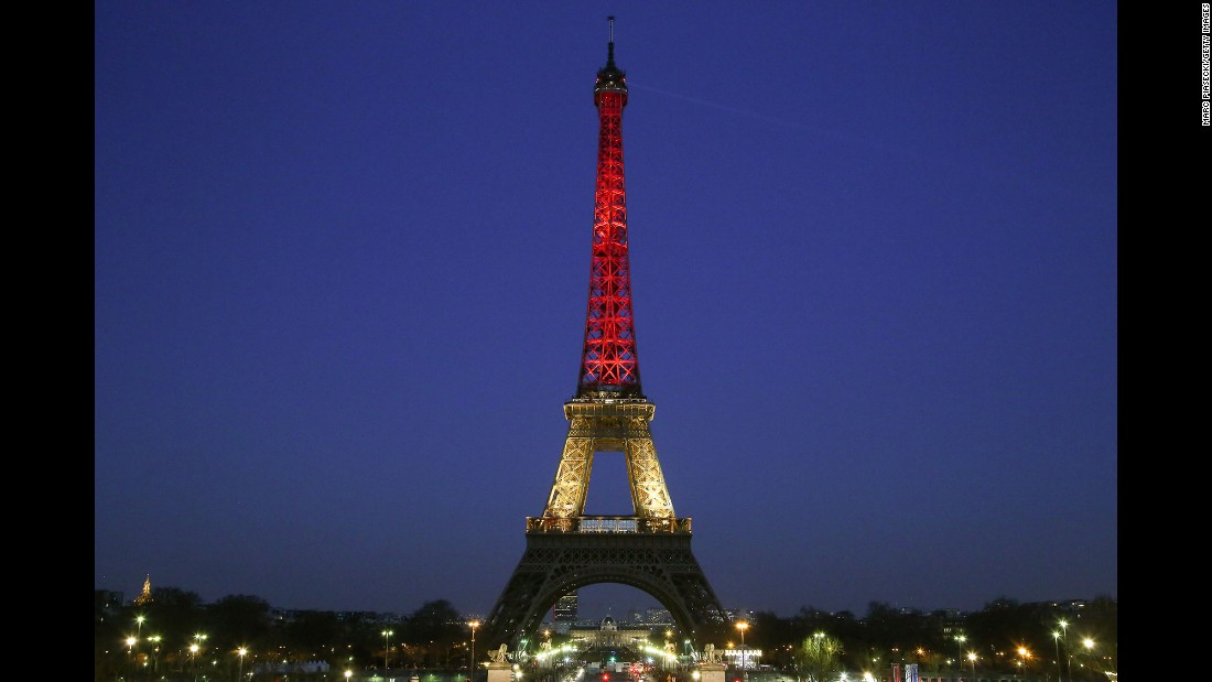 The Eiffel Tower is lit up with the colors of the Belgian flag on March 22.