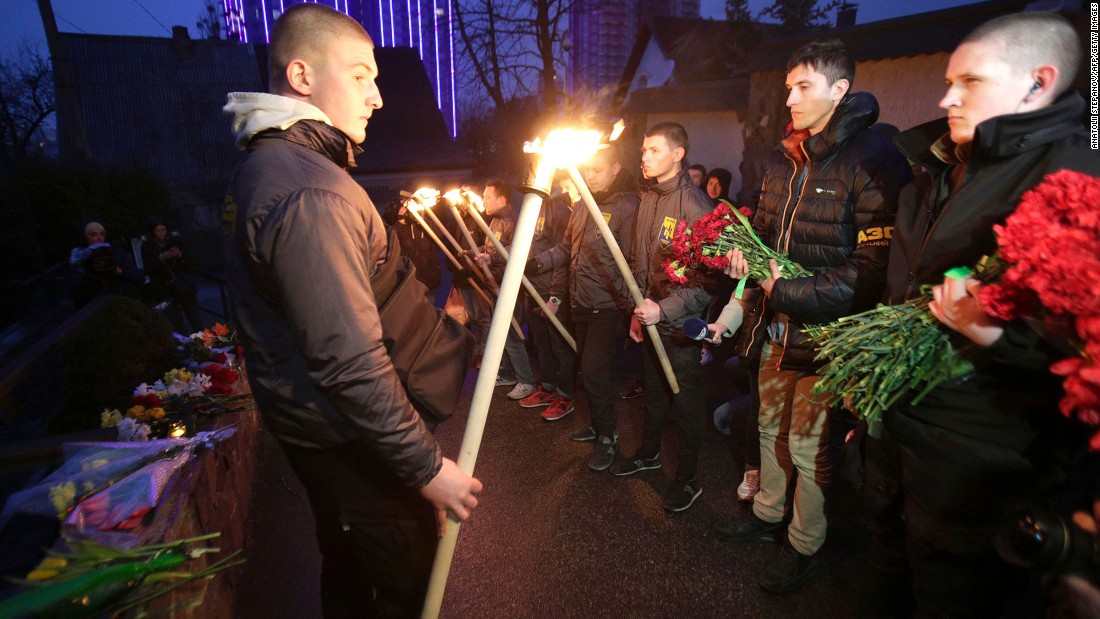 Servicemen with Azov, a Ukrainian volunteer battalion, hold torches during a tribute ceremony at the Belgian Embassy in Kiev, Ukraine, on March 22.