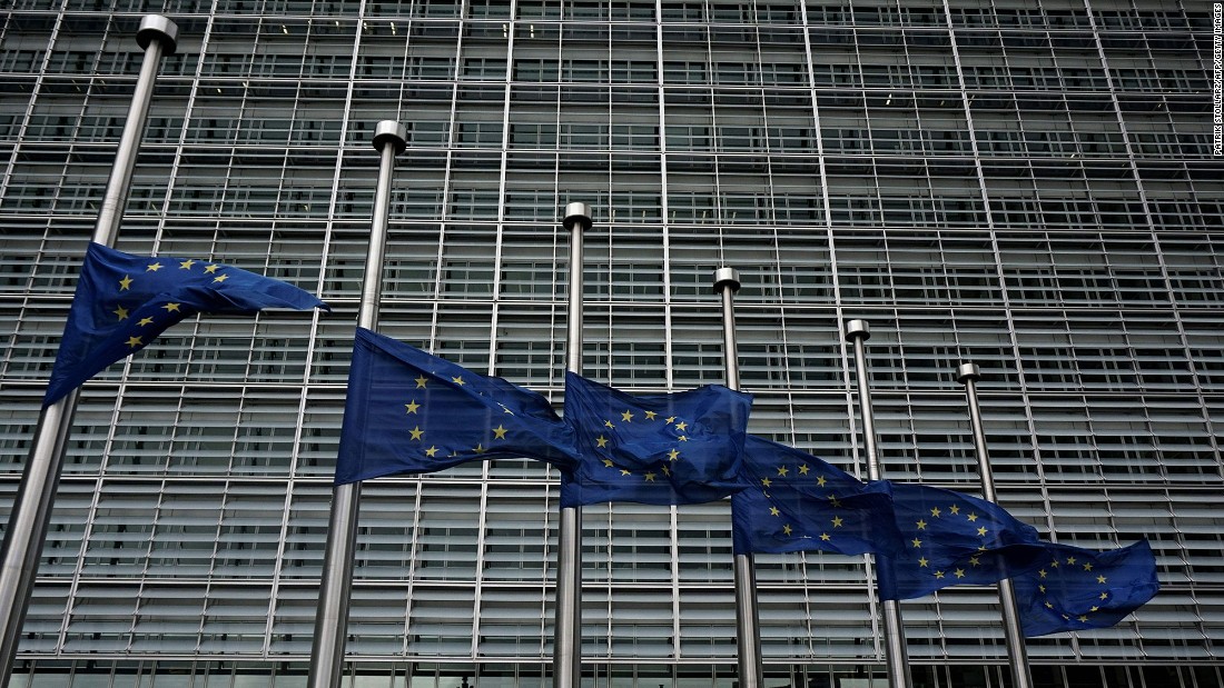 European Union flags fly at half-staff outside the European Commission in Brussels on March 23.