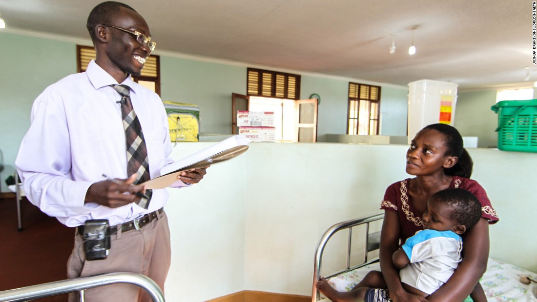 Dr. Dan, a medical officer at OneWorld Health&#39;s Masindi Kitara Medical Center, meets with a mother and her child.