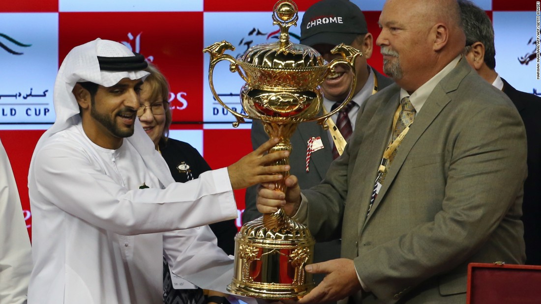 Sheikh Hamdan Bin Mohammad Bin Rashid al-Maktoum,  crown prince of Dubai, presents the owners of U.S. horse California Chrome with the Dubai World Cup trophy.