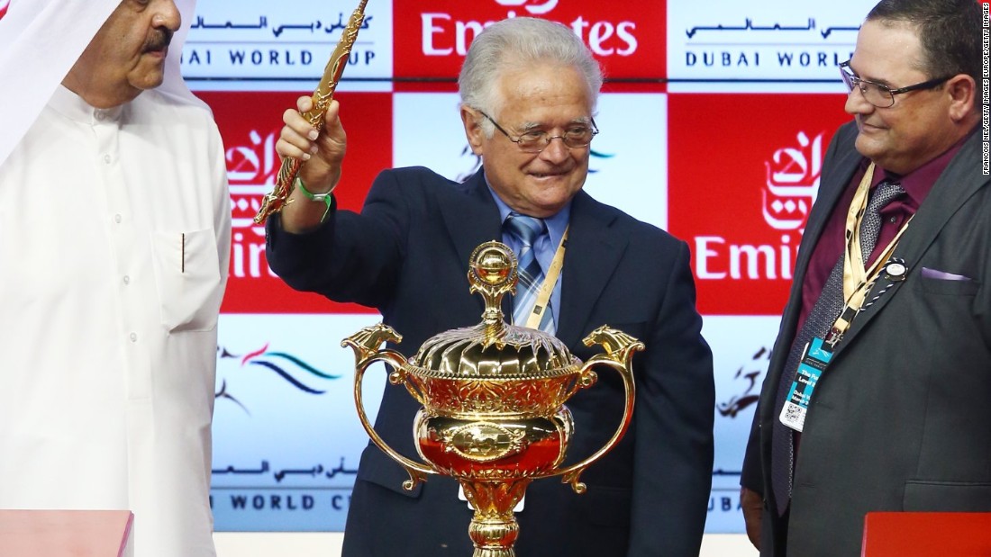Art Sherman, the legendary trainer of California Chrome, celebrates with the trophy after victory in the Dubai World Cup.