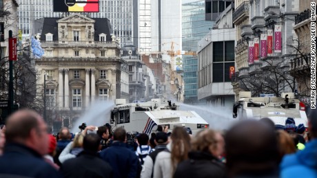 Police use water cannons to disperse anti-immigration protesters Sunday. 