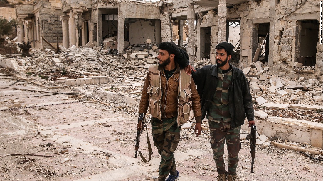 Syrian soldiers survey the damage to a villa belonging to the Qatari royal family on March 25. The villa near Palmyra served as an ISIS headquarters after being abandoned by its owner.