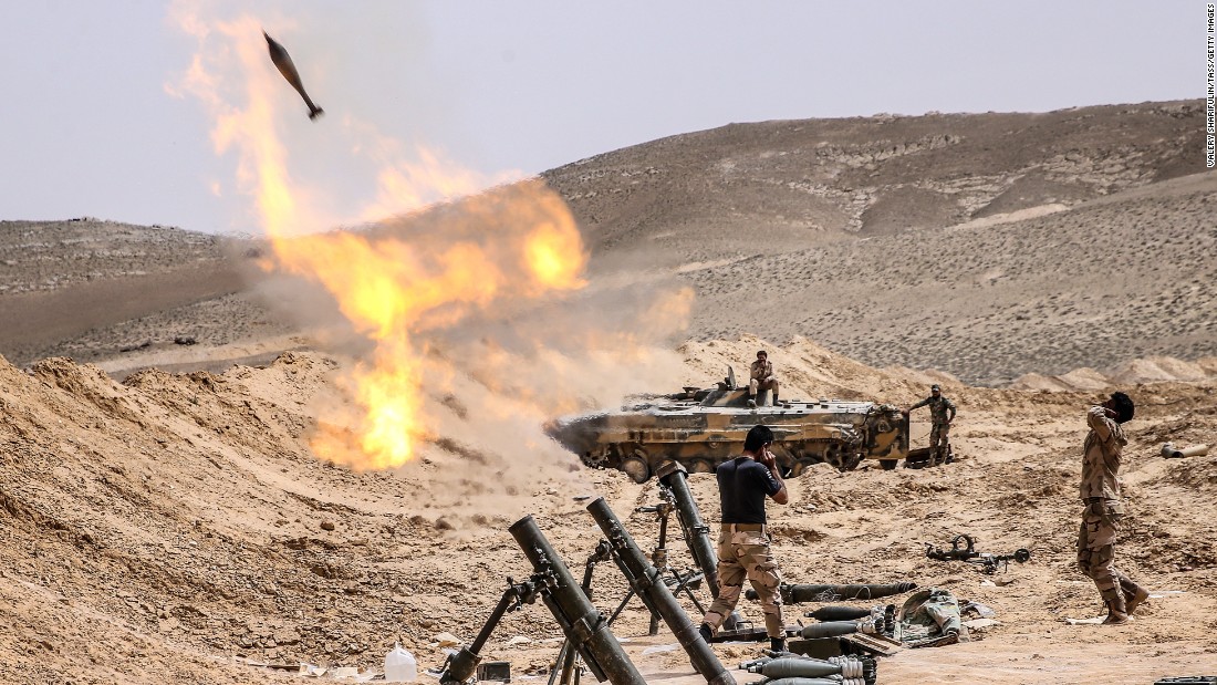 Syrian soldiers fire mortars at ISIS positions in Palmyra on March 25.