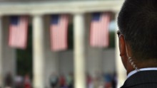 A Secret Service agent scans the crowd at the amphitheater of the Arlington National Cemetery on Memorial Day May 28, 2007 in Virginia.