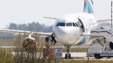 A man climbs out of the cockpit window an EgyptAir Airbus A-320 parked at the tarmac of Larnaca airport after being hijacked and diverted to Cyprus on March 29, 2016. 
The hijacker who seized the Egyptian airliner and forced it to land in Cyprus has been detained, Cypriot government spokesman Nicos Christodoulides said. / AFP / BEHROUZ MEHRI        (Photo credit should read BEHROUZ MEHRI/AFP/Getty Images)