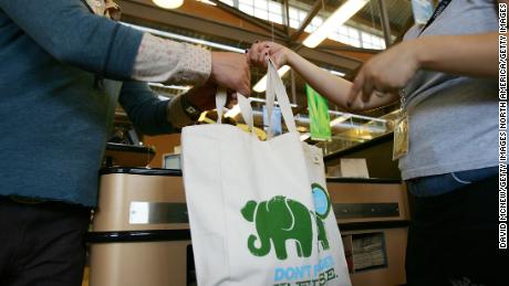 Employees hand out free reusable grocery bags at a Whole Foods Market in Pasadena, California. 