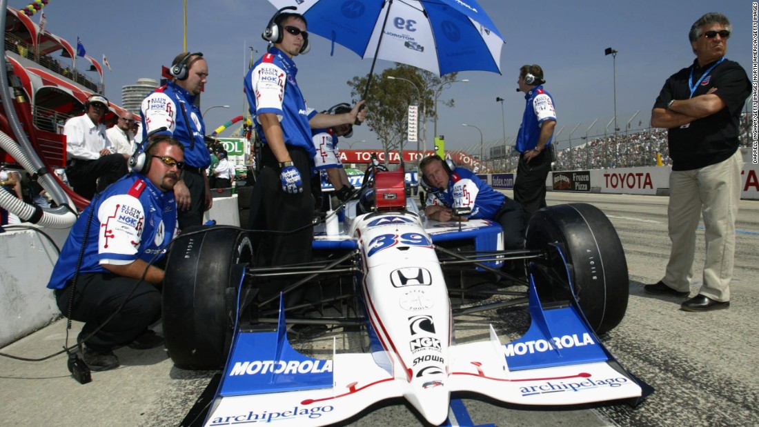  Andretti looks on as son Michael prepares for the 2002 IndyCar Long Beach Grand Prix, a race Michael would go on to win, just like his Dad. Michael Andretti is now president of the Andretti Formula E team.