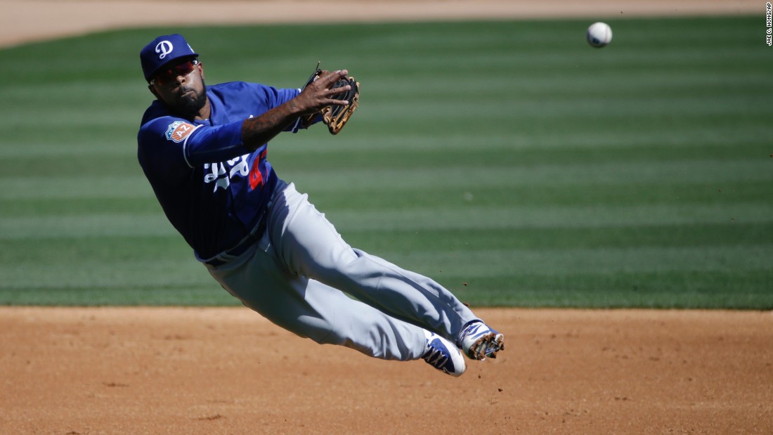 Los Angeles Dodgers second baseman Howie Kendrick throws to first base during a game in Phoenix on March 19.