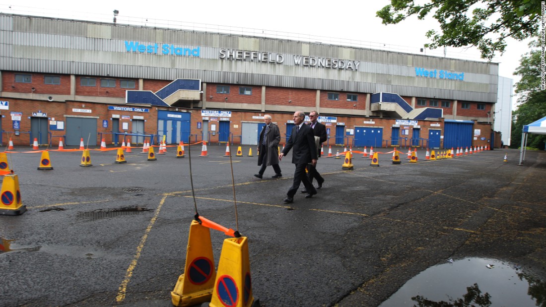 Coroner Lord Justice Goldring (centre) walks outside the Leppings Lane stand at Hillsborough as jurors examine the scene of the disaster. The cones show the layout of the area outside the ground as it had been in 1989.