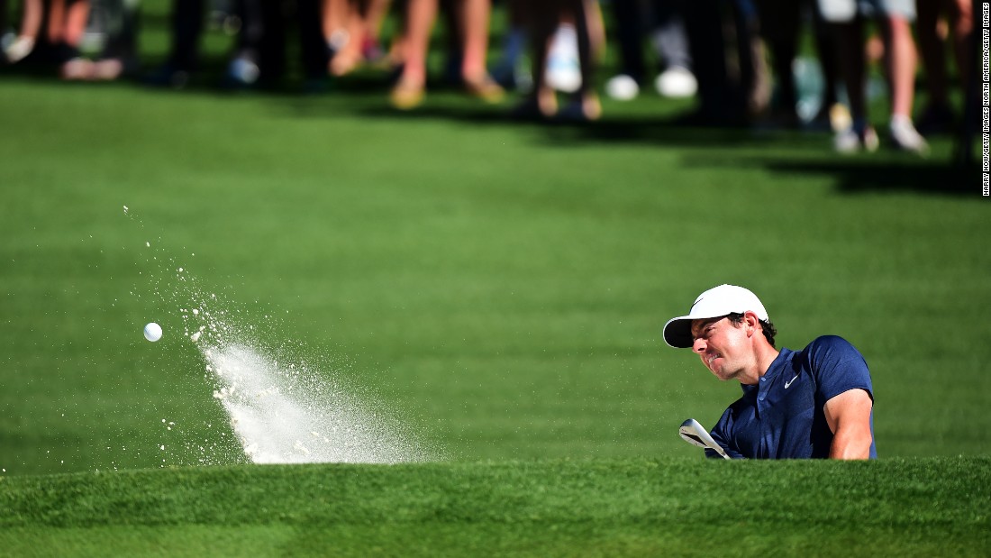 McIlroy plays out from a bunker on the second hole during his practice round. His magic moment came on the 16th.