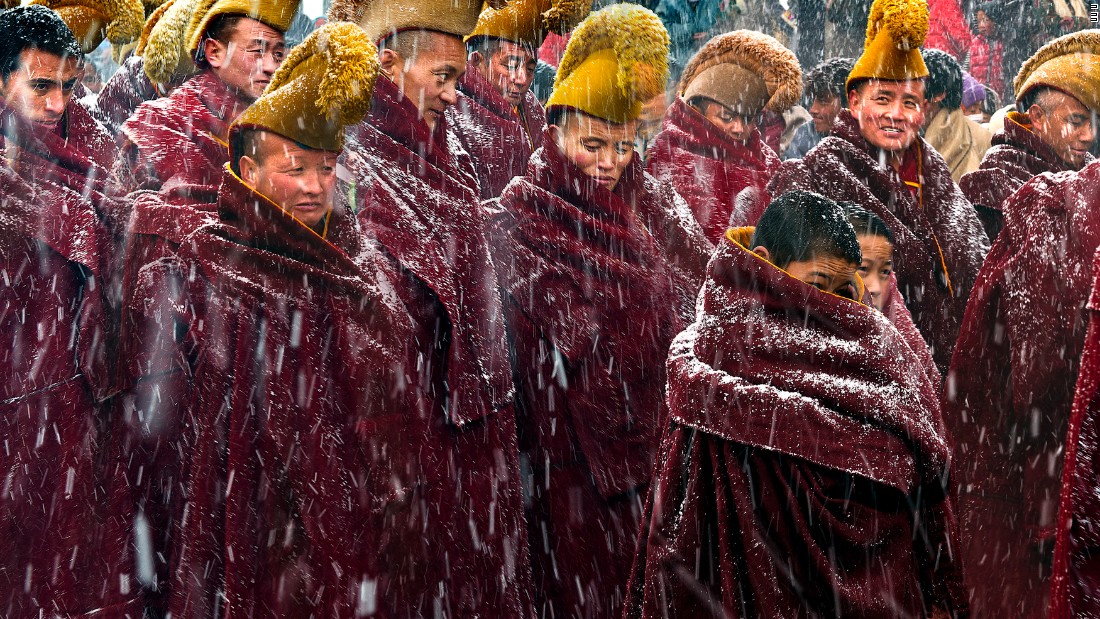Longxiang Xie was shortlisted in the open contest for this photograph of Tibetan monks at the Langmu Temple in Gansu Province, during a heavy snowfall.  