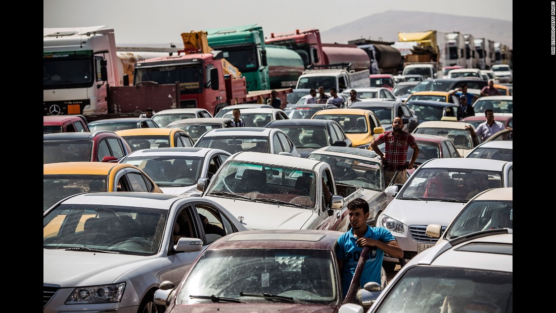 Traffic from Mosul lines up at a checkpoint in Kalak, Iraq, on June 14, 2014. Thousands of people &lt;a href=&quot;http://www.cnn.com/2014/07/19/world/meast/christians-flee-mosul-iraq/&quot; target=&quot;_blank&quot;&gt;fled Mosul&lt;/a&gt; after it was overrun by ISIS.