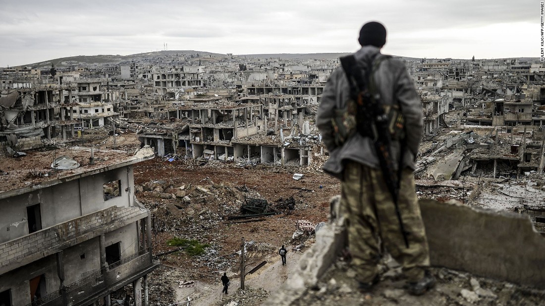 A Kurdish marksman stands atop a building as he looks at the destroyed Syrian town of Kobani on January 30, 2015. After four months of fighting, Peshmerga forces &lt;a href=&quot;http://www.cnn.com/2015/02/04/middleeast/kobani-syria-destruction/index.html&quot; target=&quot;_blank&quot;&gt;liberated the city&lt;/a&gt; from the grip of ISIS.