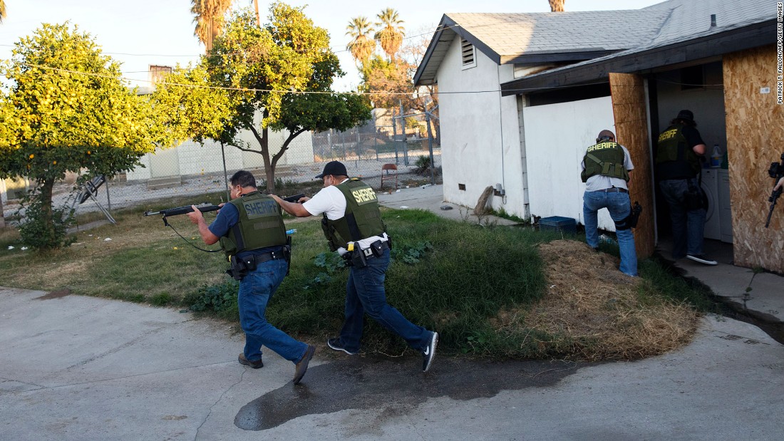 Law enforcement officers search a residential area in San Bernardino, California, after a &lt;a href=&quot;http://www.cnn.com/2015/12/02/us/gallery/san-bernardino-shooting/index.html&quot; target=&quot;_blank&quot;&gt;mass shooting&lt;/a&gt; killed at least 14 people and injured 21 on December 2, 2015. &lt;a href=&quot;http://www.cnn.com/2015/12/03/us/san-bernardino-shooting/index.html&quot; target=&quot;_blank&quot;&gt;The shooters&lt;/a&gt; -- Syed Rizwan Farook and his wife, Tashfeen Malik -- were fatally shot in a gunbattle with police hours after the initial incident. The couple supported ISIS and had been planning the attack for some time, investigators said.