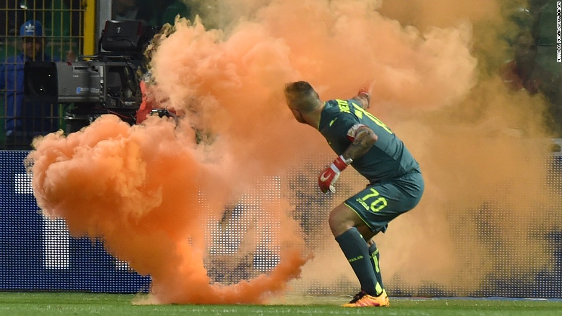A flare is thrown onto the field near Palermo goalkeeper Stefano Sorrentino during an Italian league match in Palermo on Sunday, April 10. The match was stopped twice because of crowd trouble, &lt;a href=&quot;http://www.bbc.com/sport/football/36011691&quot; target=&quot;_blank&quot;&gt;according to the BBC.&lt;/a&gt;