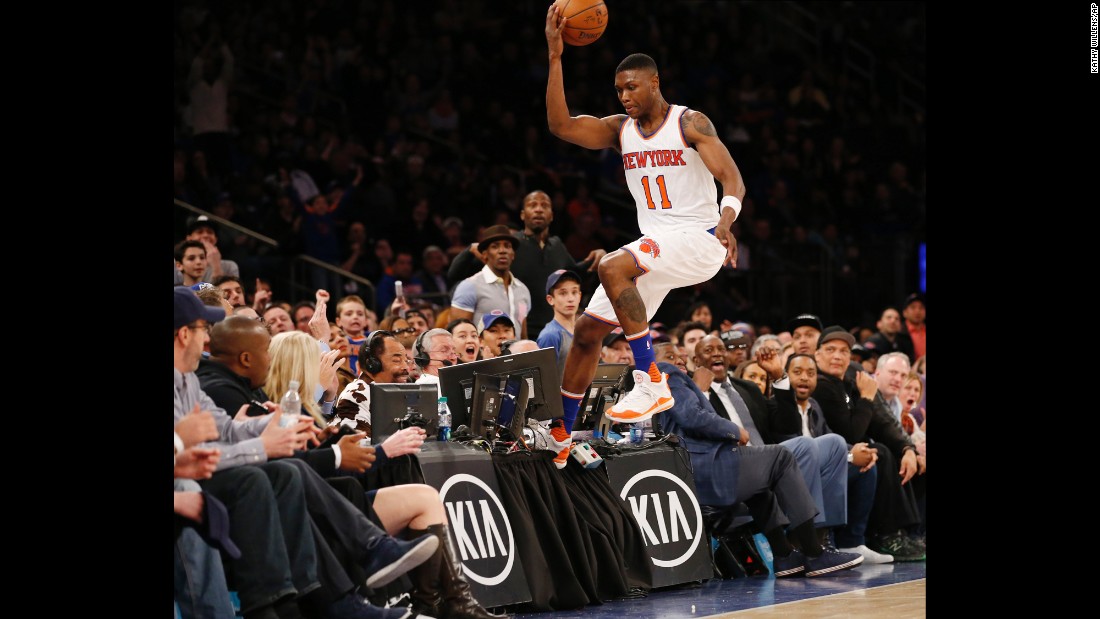 Cleanthony Early steps on a broadcast table as he tries to save a ball from going out of bounds Sunday, April 10, in New York.
