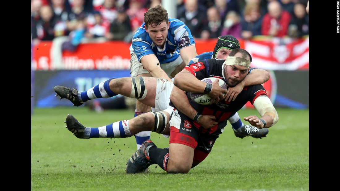 Gloucester Rugby&#39;s John Alofa is tackled by Nic Cudd of the Newport Gwent Dragons during a Challenge Cup match in Gloucester, England, on Saturday, April 9. The Dragons, who play in Newport, Wales, won 23-21 to advance to the semifinals of the European tournament.