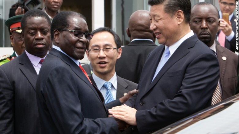 China&#39;s President Xi Jinping shakes  hands  with Zimbabwe&#39;s President Robert Mugabe in Harare 