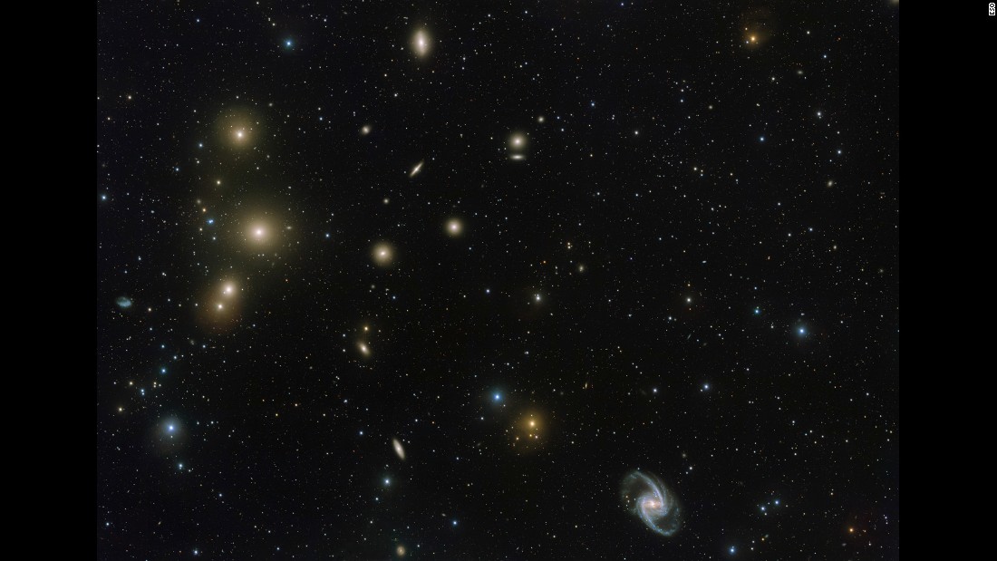 This image from the VLT Survey Telescope at ESO&#39;s Paranal Observatory in Chile shows a stunning concentration of galaxies known as the Fornax Cluster, which can be found in the Southern Hemisphere. At the center of this cluster, in the middle of the three bright blobs on the left side of the image, lies a cD galaxy -- a galactic cannibal that has grown in size by consuming smaller galaxies.