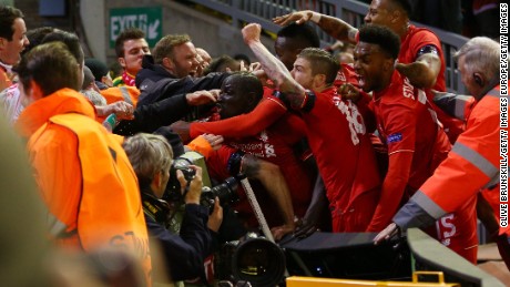 Liverpool players and fans mob Dejan Lovren after his crucial goal.
