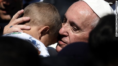 Pope Francis hugs a child at the Moria detention center in Mytilene on April 16, 2016.  
Pope Francis received an emotional welcome today on the Greek island of Lesbos during a visit aimed at showing solidarity with migrants fleeing war and poverty. Pope Francis, Orthodox Patriarch Bartholomew and Archbishop Jerome visit Lesbos today to turn the spotlight on Europe&#39;s controversial deal with Turkey to end an unprecedented refugee crisis. / AFP / ARIS MESSINIS        (Photo credit should read ARIS MESSINIS/AFP/Getty Images)