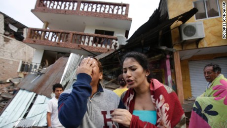 A woman cries as she stands next to house destroyed by the earthquake in the Pacific coastal town of Pedernales, Ecuador, Sunday, April 17, 2016. The strongest earthquake to hit Ecuador in decades flattened buildings and buckled highways along its Pacific coast, sending the Andean nation into a state of emergency. As rescue workers rushed in, officials said Sunday at least 77 people were killed, over 570 injured and the damage stretched for hundreds of miles to the capital and other major cities.(AP Photo/Dolores Ochoa)