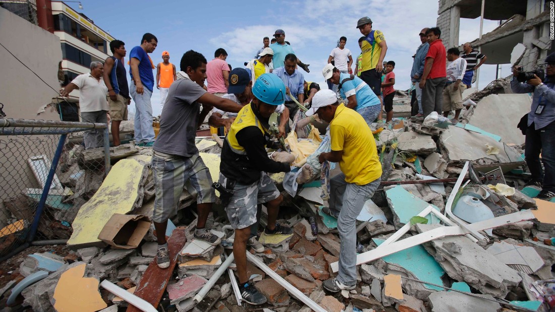 Volunteers remove a body from a destroyed house  in Pedernales, Ecuador, on April 17.