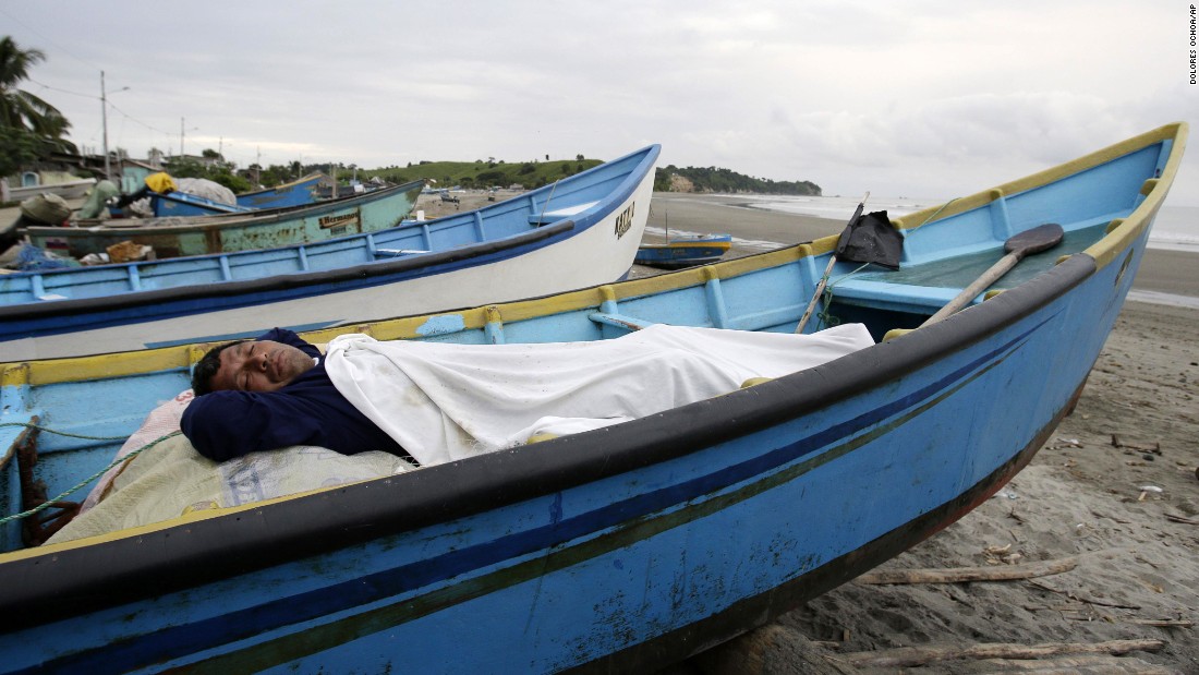 A man, his home destroyed by the earthquake, sleeps in a boat docked along the shore in La Chorrera on April 18.
