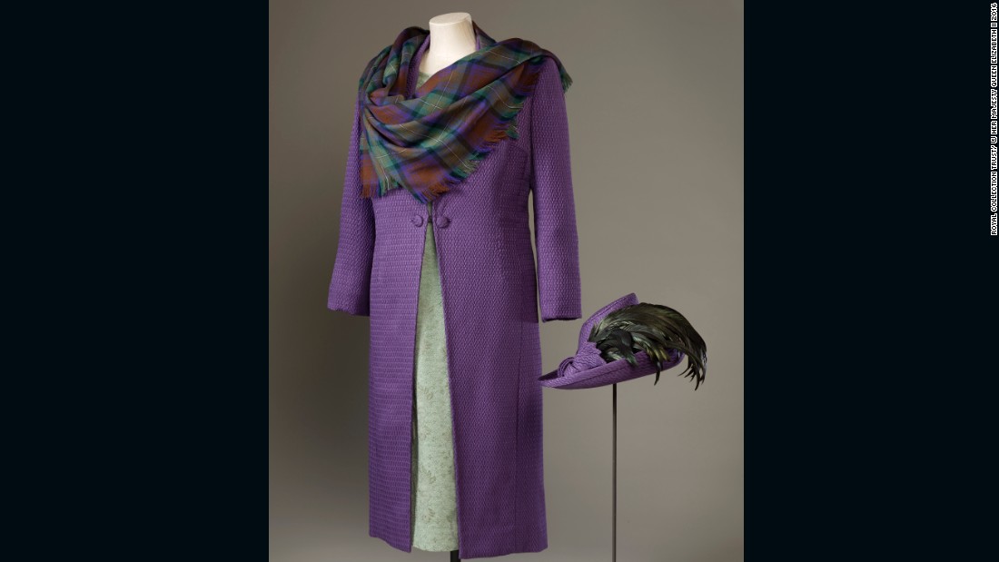 Purple silk-wool coat with a green silk-crepe and lace dress, and a shawl of purple and green Isle of Skye tartan by Sandra Murray, worn to the official opening of the Scottish Parliament on July 1, 1999. 