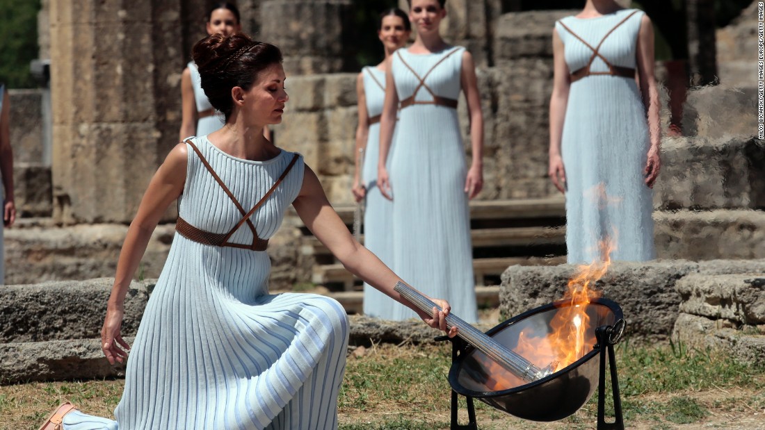 The flame is lit at the Ancient Stadium in Olympia, Greece, and initially derived from the sun&#39;s rays in a parabolic mirror. After an elaborate ceremony, it is handed over to the first torchbearer. 
