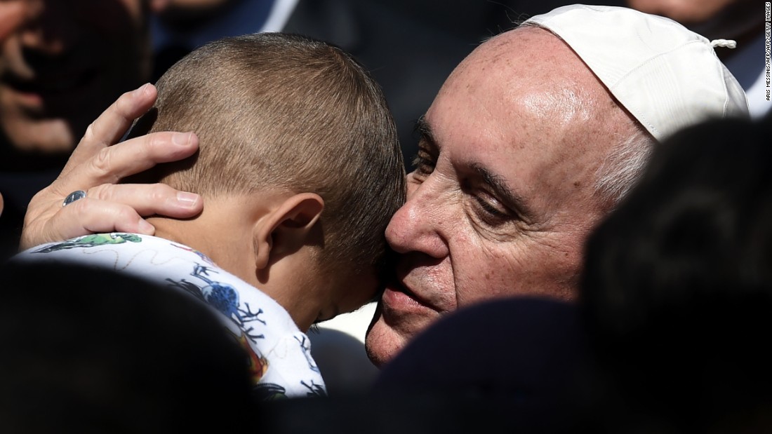 Pope Francis hugs a child at the Moria refugee camp on the Greek island of Lesbos on Saturday, April 16, 2016. Pope Francis received an emotional welcome on the island &lt;a href=&quot;http://www.cnn.com/2016/04/16/europe/pope-visits-refugees-lesbos/&quot; target=&quot;_blank&quot;&gt;during a visit showing solidarity&lt;/a&gt; with migrants fleeing war and poverty.
