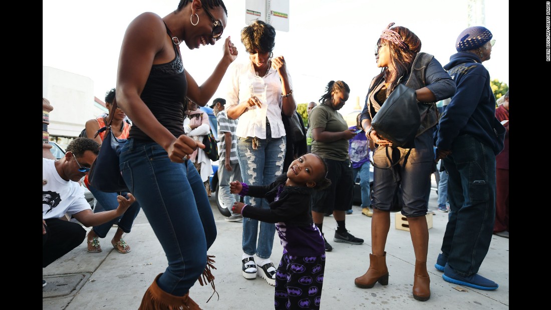 People dance in the street to the music of Prince at Leimert Park in Los Angeles on April 21.