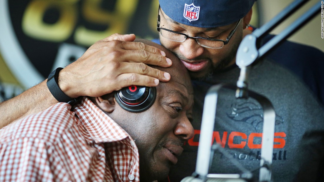 KMOJ DJs Walter &quot;Q Bear&quot; Banks, left, and Shed G embrace as they talk about the death of Prince on April 21.