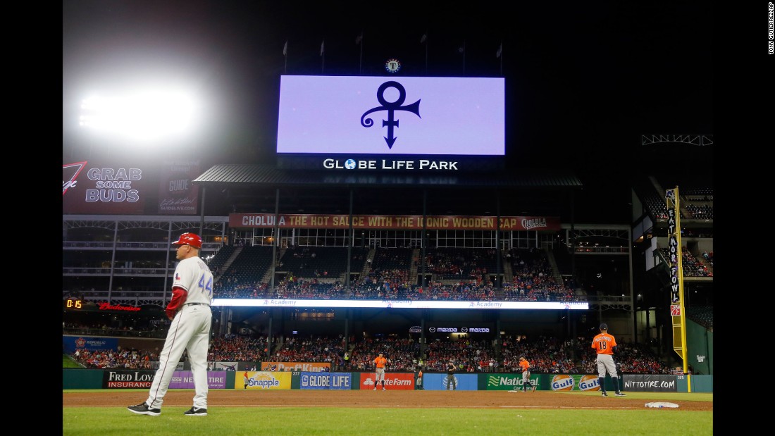 Prince&#39;s symbol is broadcast on the Texas Rangers video screen over the right field roof during a game between the Rangers and Houston Astros in Arlington, Texas.