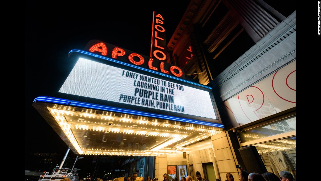 People gather outside the Apollo Theater in New York to mourn and celebrate the life of Prince on April 21.