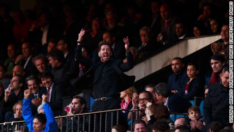 Diego Simeone enocourages the crowd from the stand after being sent off during Atletico Madrid&#39;s match with Malaga.
