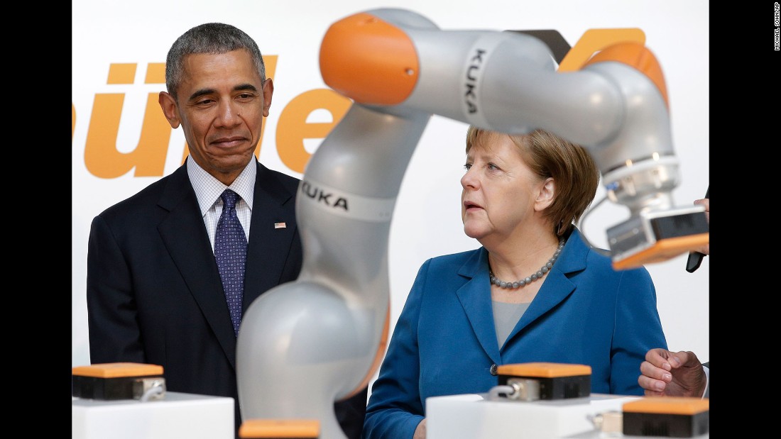 Obama and Merkel look at a robotic device April 25 as they tour the Hannover Messe, the world&#39;s largest trade fair for industrial technology.
