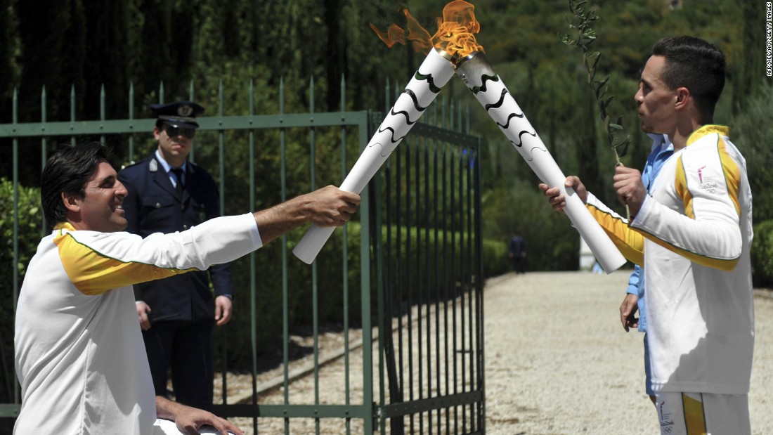 Petrounias passed the Olympic flame to a second torchbearer on April 21 -- Brazilian volleyball player, Giovane Gávio (L).