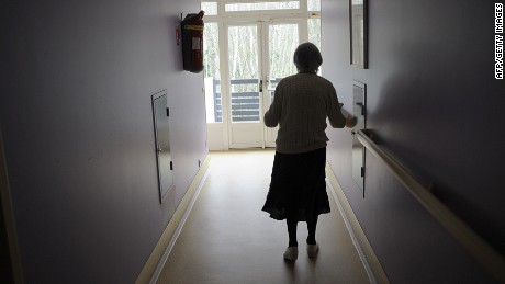 A woman, suffering from Alzheimer&#39;s desease, walks in a corridor on March 18, 2011 in a retirement house in Angervilliers, eastern France.   AFP PHOTO / SEBASTIEN BOZON (Photo credit should read SEBASTIEN BOZON/AFP/Getty Images)
