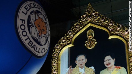 Leicester&#39;s club logo next to a portrait of Thai King Bhumibol Adulyadej and Queen Sirikit. 